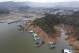 FILE - Boats sit docked around the exposed banks of the El Penol-Guatape hydroelectric dam, due to low water levels, in Guatape, Colombia, April 3, 2024. Colombia’s government on Tuesday, April 23, 2024, rolled out new incentives to reduce electricity consumption in the South American nation, which has been hit by a severe drought that has diminished the capacity of local hydroelectric plants and brought officials close to imposing power cuts. (AP Photo/Fredy Amariles, file)