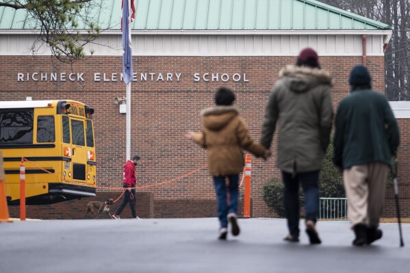FILE - Students return to Richneck Elementary in Newport News, Va., on Jan. 30, 2023. In the moments after a 6-year-old shot his teacher in a Virginia classroom this past January, the child made statements to a reading specialist like, “I shot that (expletive) dead,” according to police search warrants that were unsealed in July. (Billy Schuerman/The Virginian-Pilot via AP)