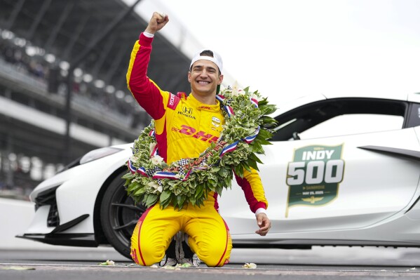 Alex Palou, of Spain, celebrates on the Yard of Bricks on the start/finish line after winning the Indianapolis 500 auto race at Indianapolis Motor Speedway in Indianapolis, Sunday, May 25, 2025. (AP Photo/AJ Mast)