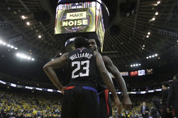 
              Los Angeles Clippers guard Lou Williams (23) celebrates with Patrick Beverley during the second half of Game 2 of a first-round NBA basketball playoff series against the Golden State Warriors in Oakland, Calif., Monday, April 15, 2019. (AP Photo/Jeff Chiu)
            