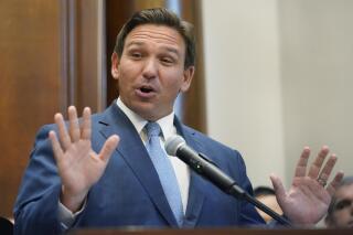 Florida Gov. Ron DeSantis gestures as he speaks, Monday, June 14, 2021, at the Shul of Bal Harbour, a Jewish community center in Surfside, Fla. DeSantis visited the South Florida temple to denounce anti-Semitism and stand with Israel, while signing a bill into law that would require public schools in his state to set aside moments of silence for children to meditate or pray. (AP Photo/Wilfredo Lee)