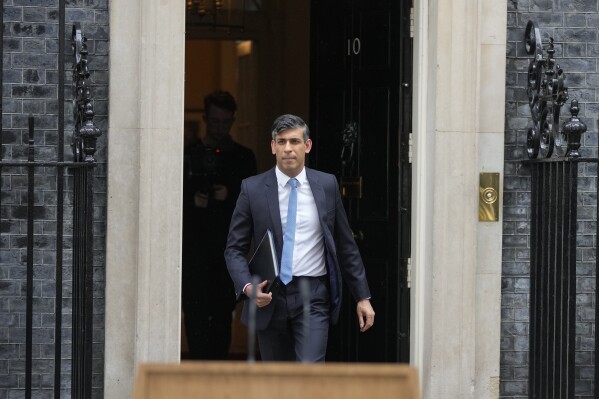 Britain's Prime Minister Rishi Sunak walks from 10 Downing Street to speak to the media in London Wednesday, May 22, 2024, as he announces that he is to call a General Election for July 4. (AP Photo/Kin Cheung)