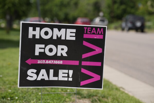 A for sale sign stands outside a single-family residence on the market Sunday, June 18, 2023, in Denver. On Thursday, the National Association of Realtors reports on sales of existing homes in May. (AP Photo/David Zalubowski)