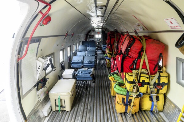 Gear lines the inside of a plane that carries smokejumpers parachuting into Canadian wildfires on Saturday, July 1, 2023, in Fort St. John, British Columbia. (AP Photo/Noah Berger)