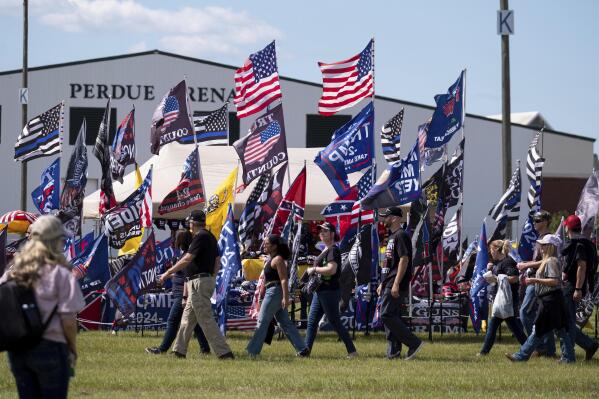 Supporters file into the Georgia National Fairgrounds in Perry, Ga., to attend former president Donald Trump's "Save America" rally Saturday, Sept. 25, 2021. (AP Photo/Ben Gray)