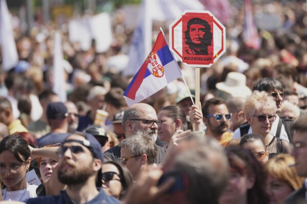 University students and people protest in front of the government building, six months after the deadly train station tragedy that sparked mass demonstrations against corruption, in Belgrade, Serbia, Thursday, May 1, 2025. (AP Photo/Darko Vojinovic)