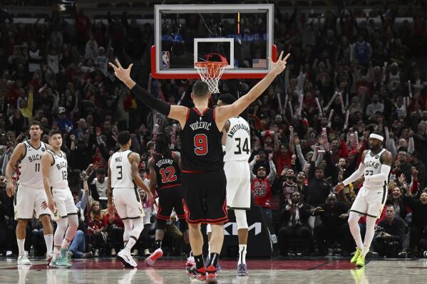 Chicago Bulls' Nikola Vucevic (9) gestures after scoring a 3-point basket against Milwaukee Bucks' Giannis Antetokounmpo (34) during overtime in an NBA basketball game Wednesday, Dec. 28, 2022, in Chicago. (AP Photo/Quinn Harris)