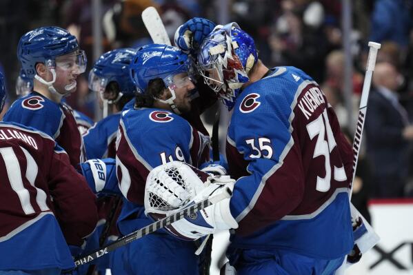 Colorado Avalanche defenseman Samuel Girard (49) and goaltender Darcy Kuemper (35) celebrate the team's win against the Carolina Hurricanes in an NHL hockey game Saturday, April 16, 2022, in Denver. (AP Photo/Jack Dempsey)