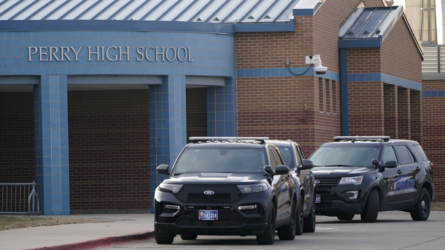 Iowa principal who risked his life to protect students during a high school shooting has died