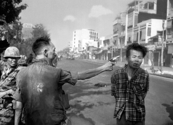FILE - South Vietnamese National Police Chief Brig Gen. Nguyen Ngoc Loan executes a suspected Viet Cong officer with a single pistol shot in the head in Saigon, Vietnam, Feb. 1, 1968. The image won the 1969 Pulitzer Prize for spot news photography. Hal Buell, who led The Associated Press' photo operations from the darkroom era into the age of digital photography over a four-decade career with the news organization that included 12 Pulitzer Prizes and some of the defining images of the Vietnam War, has died. He was 92. (AP Photo/Eddie Adams, File)