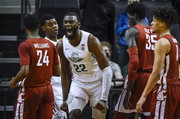 Oregon center Franck Kepnang (22) reacts after making basket and being fouled, as Oregon forward Eric Williams Jr. (50) stands at left and Washington State guard Noah Williams (24), forward Mouhamed Gueye (35) and forward DJ Rodman (11) watch during the second half of an NCAA college basketball game Monday, Feb. 14, 2022, in Eugene, Ore. (AP Photo/Andy Nelson)