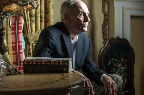FILE - In this March 7, 2013 file photo, former Los Angeles prosecutor Vincent Bugliosi sits next to his book: "Reclaiming History: The Assassination of President John F. Kennedy" at his home in Pasadena, Calif. Bugliosi was an ambitious but anonymous deputy district attorney when he was handed the Manson Family murder trial after a more experienced prosecutor was removed for mocking one of the defendants to reporters. He denounced Manson as the "dictatorial maharajah of a tribe of bootlicking slaves," calling Manson's followers "robots" and "zombies." After their convictions, he recounted the case in "Helter Skelter," one of history's best-selling true-crime books. He died of cancer at age 80 in 2015. (AP Photo/Damian Dovarganes, File)