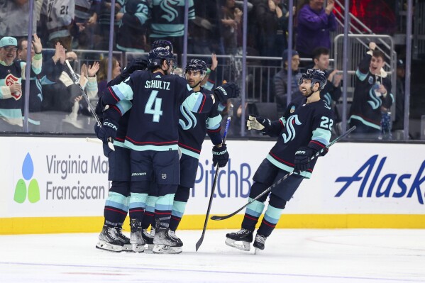 The Seattle Kraken celebrate a goal by left wing Jared McCann against the San Jose Sharks during the second period in an NHL hockey game Wednesday, Nov. 22, 2023, in Seattle. (AP Photo/Maddy Grassy)
