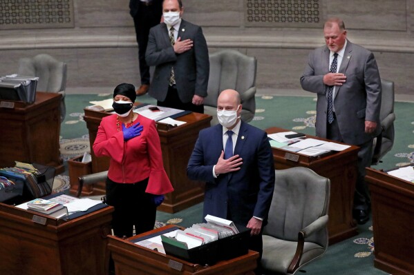 FILE - Missouri State Sen. Jamilah Nasheed, D-St. Louis, stands alongside Sen. Tony Luetkemeyer, R- Platte County, during the pledge of allegiance at the state of the session, April 8, 2020, at the Missouri Capitol in Jefferson City, Mo. (Laurie Skrivan/St. Louis Post-Dispatch via AP, File)