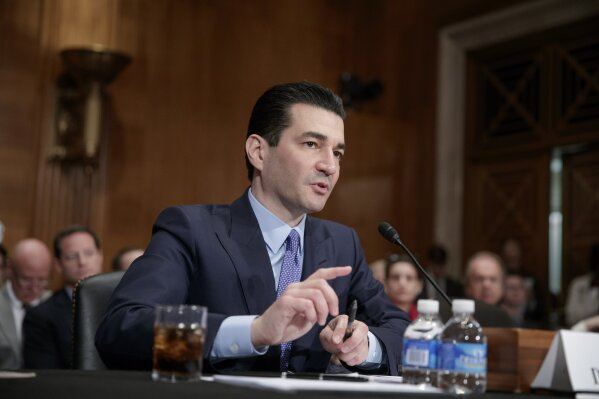 FILE - IN this April 5, 2017, file photo, Dr. Scott Gottlieb, President Donald Trump's nominee to head the powerful Food and Drug Administration (FDA), speaks during his confirmation hearing before the Senate Committee on Health, Education, Labor, and Pensions, on Capitol Hill in Washington. Vaping giant Juul Labs has donated thousands of dollars to court state attorneys general. But the lobbying strategy may be backfiring. “Juul really created this crisis,” said Gottlieb, the former Food and Drug Administration commissioner. “Juul created the pool of nicotine-addicted teens and I think they popularized the idea of vaping among kids.” (AP Photo/J. Scott Applewhite, File)