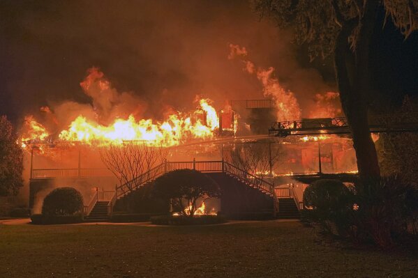 In this photo provided by the Glynn County Fire Department, the house of Hall of Fame golfer Davis Love III is destroyed by fire early Friday morning, March 27, 2020, on St. Simons Island, Ga.,  in a blaze that could not be controlled, even with 16 firefighters arriving within minutes, the fire chief said. No one from Love's family was injured. (Kyle Jurgens/Glynn County Fire Department via AP)