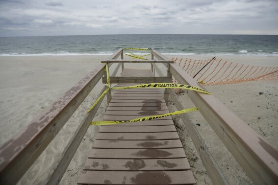 In a photo taken Thursday, Oct. 27, 2016, security tape hangs from an incomplete access to the beach in Mantoloking, New Jersey. (AP Photo/Julio Cortez)