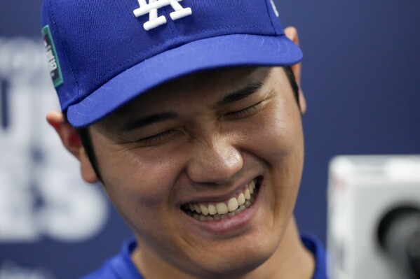 Los Angeles Dodgers' Shohei Ohtani reacts during a news conference ahead of a baseball workout at the Gocheok Sky Dome in Seoul, South Korea, Saturday, March 16, 2024. (AP Photo/Lee Jin-man)