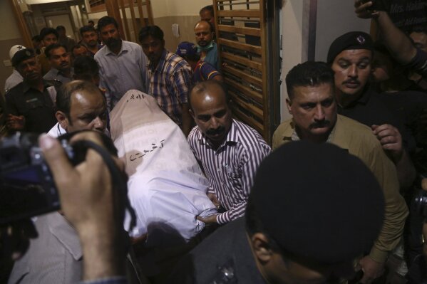 
              FILE - In this Feb. 5, 2018 file photo, people carry the body of a Chinese national who was killed when gunmen opened fire on two Chinese nationals, at a hospital in Karachi, Pakistan. The assault on the Chinese consulate in Karachi, Friday, Nov. 13, 2018, was the latest in a series of attacks on China’s growing influence in Pakistan, where Beijing is financing tens of billions of dollars’ worth of megaprojects that critics fear will plunder the country’s resources and leave it with crippling debt. (AP Photo/Shakil Adil)
            