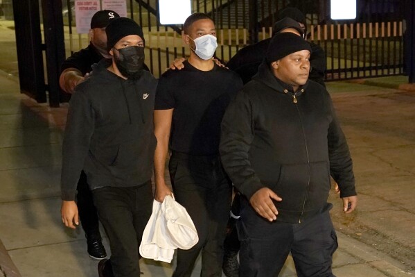 FILE - Actor Jussie Smollett, center, leaves the Cook County Jail, March 16, 2022, in Chicago. Smollett’s drawn out legal saga begins anew Tuesday, Sept. 12, 2023, when an Illinois appeals court will hear oral arguments that the former “Empire” actor’s convictions for staging a racist, homophobic attack against himself in 2019 and then lying about it to Chicago police should be tossed. (AP Photo/Charles Rex Arbogast, File)