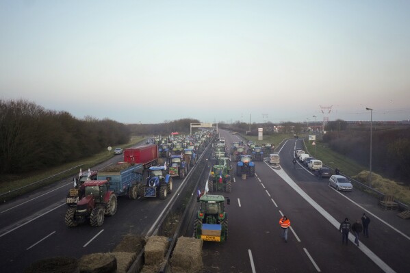 FILE - Farmers occupy a highway with tractors in Urdi, south of Paris, Wednesday, January 31, 2024. As protesting farmers camped out on barricades around Paris, the French government on Tuesday hoped to calm their anger with further concessions.  , 2024, in response to complaints that growing and raising food had become too difficult and not profitable enough.  (AP Photo/Thibault Camus, File)