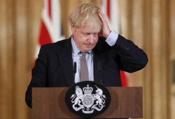 FILE - Britain's Prime Minister Boris Johnson reacts during a press conference at Downing Street on the government's coronavirus action plan in London on March 3, 2020. For Boris Johnson, facts have always been flexible. The British prime minister’s career is littered with doctored quotes, tall tales, exaggerations and mistruths. When called out, he has generally offered an apologetic shrug or a guilty grin, and moved on. At least until now. Revelations that the prime minister and his staff partied while Britain was under coronavirus restrictions has provoked  public outrage. (AP Photo/Frank Augstein, File)