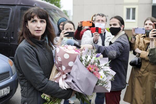 Belarusian journalist Katsiaryna Barysevich, who was sentenced to six months over her investigation into a protester's death, holds bunches of flowers surrounded by her colleagues upon her release from prison in Minsk, Belarus, Wednesday, May 19, 2021. Barysevich was released on Wednesday after serving her time in a penal colony in Gomel, a city in southeastern Belarus. "I have been a journalist for 15 years and have never even thought I could end up in jail," Barysevich said after leaving the facility. (AP Photo)
