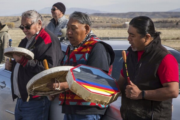 Big Wind Singers Lyle Oldman, from left, Wayland Bonatsie and Jake Hill perform a Sun Dance song during the buffalo release at the Eastern Shoshone Buffalo Enclosure on Friday, April 11, 2025, on the Wind River Reservation near Morton, Wyo. (AP Photo/Amber Baesler)