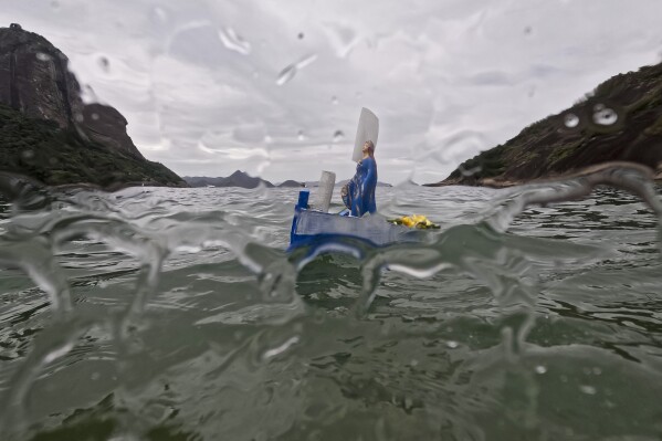 A small-scaled boat with offerings for Yemanja, the African goddess of the sea, floats near Vermelha beach in Rio de Janeiro, Brazil, Dec. 31, 2023. As the year winds down, Brazilian worshippers honor Yemanja by offering flowers and launching large and small boats into the water in exchange for blessings for the coming year. (AP Photo/Bruna Prado)