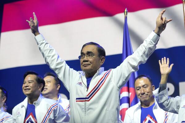 Thailand's Prime Minister Prayuth Chan-ocha , center, officially gestures as he announces he is joining the United Thai Nation Party as a newly-established party's candidate in Bangkok, Thailand, Monday, Jan. 9, 2023. Prayuth, who first came to power as army chief leading a coup in 2014, became prime minister in an elected government in 2019 as the candidate of the military-backed Palang Pracharath Party, but has split with his former colleagues to become the candidate for Ruam Thai Sang Chart, or United Thai Nation Party, in this year's not-yet-scheduled general election. (AP Photo/Sakchai Lalit)