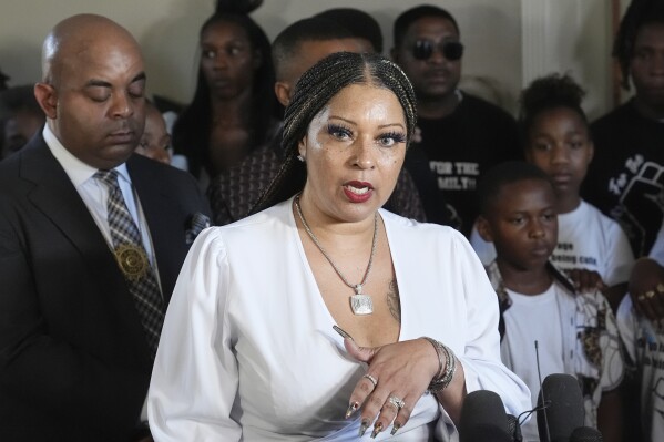 Katt McKinney, founder of Glendale-based advocacy group Black Women of Faith, joins with several alledged victims of civil rights violations, speaks during a news conference Friday, June 14, 2024, in Phoenix. Phoenix activists gathered to discuss the Department of Justice probe, accusing the police force in the nation's fifth-largest city of discriminating against Black, Hispanic and Native American people, unlawfully detaining homeless people and using excessive force. (AP Photo/Ross D. Franklin)