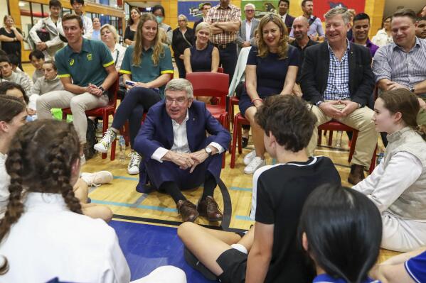 International Olympic Committee President Thomas Bach, center, speaks with young athletes at the Olympics Unleashed session at the Yeronga Park Sports Centre in Brisbane, Australia, Saturday, May 7, 2022. Bach was in Brisbane on Saturday for the first time since the Queensland state capital was awarded the 2032 Olympics. (Jason O'Brien/AAP Image via AP)