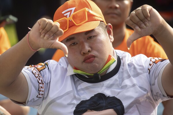 A supporter of Move Forward Party reacts outside parliament during vote counting, in Bangkok, Thailand, Thursday, July 13, 2023. Pita, whose Move Forward Party ran first in Thailand's May 14 general election, was nominated to be prime minister at a joint session of Parliament's Upper and Lower House on Thursday, but failed to attain the majority vote needed to win the job, necessitating a new round of voting expected next week. (AP Photo/Wason Wanichakorn)