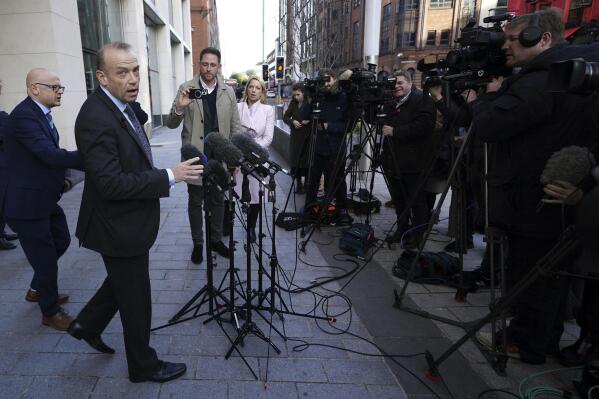 Northern Ireland Secretary Chris Heaton-Harris speaks to the media outside Erskine House, Belfast, Britain, Friday Oct. 28, 2022. Heaton-Harris denied his decision not to call an election immediately was a U-turn. "I am still going to be calling an election," he added. (Brian Lawless/PA via AP)