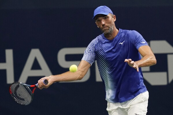 FILE - Ivo Karlovic, of Croatia, returns a shot to Richard Gasquet, of France, during the first round of the U.S. Open tennis championships in New York, on Sept. 1, 2020. Karlovic has officially announced his retirement from tennis after having not played a tournament match in 2 1-2 years. (APPhoto/Frank Franklin II, File)