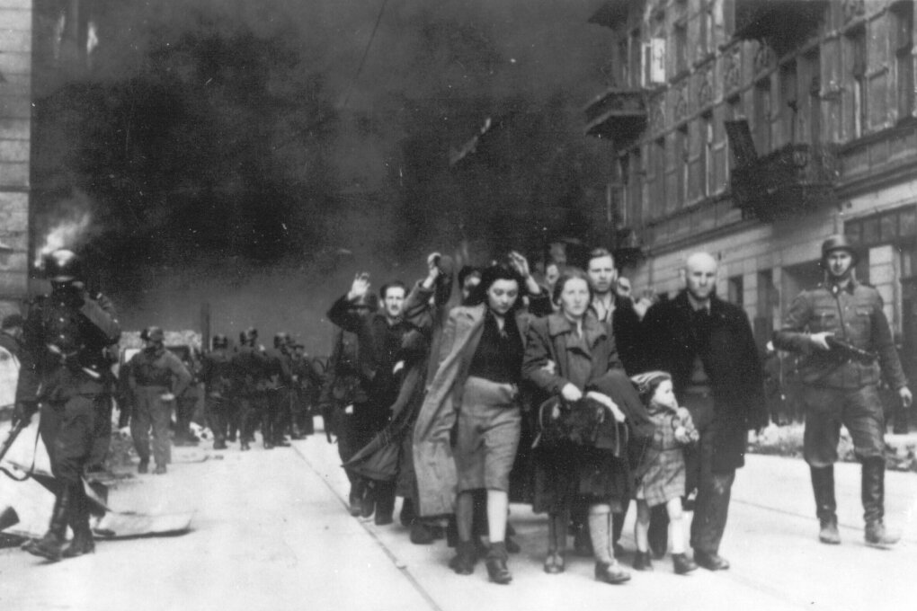 FILE - In this 1943 photo, a group of Polish Jews are led away for deportation by German SS soldiers, during the destruction of the Warsaw Ghetto by German troops after an uprising in the Jewish quarter. Two Polish historians are facing a libel trial for a scholarly examination of Polish behavior during World War II, a case whose outcome is expected to determine the fate of independent Holocaust research under Poland’s nationalist government. A verdict is expected Feb. 9. (AP Photo, B/W File)