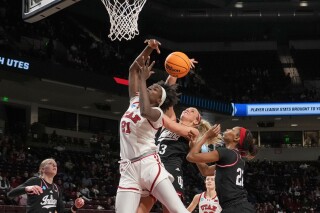 Indiana guard Sydney Parrish (33) blocks shot of Utah forward Maye Toure (21) during the second half in the first round of the NCAA college basketball tournament, Friday, March 21, 2025, in Columbia, S.C. (AP Photo/David Yeazell)