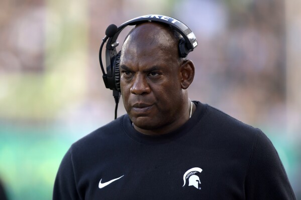 FILE - Michigan State coach Mel Tucker walks the sideline during the second half of an NCAA college football game against Richmond, Saturday, Sept. 9, 2023, in East Lansing, Mich. Michigan State athletic director Alan Haller has informed suspended football coach Mel Tucker he is being fired for cause without compensation for his conduct with activist and rape survivor Brenda Tracy. “The notice provides Tucker with seven calendar days to respond and present reasons to me and the interim president as to why he should not be terminated for cause,” Haller said in a statement sent by the school on Monday, Sept. 18. (AP Photo/Al Goldis, File)