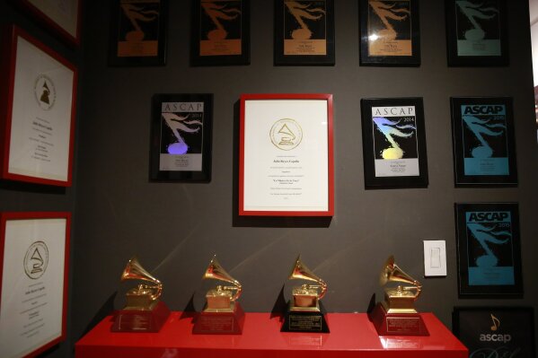 Awards hang on the wall in Colombian producer Julio Reyes Copello's new Abbey Road Institute on Tuesday, Feb. 25, 2020, in Miami. The Abbey Road Institute announced that it will open its first music school in the United States in partnership with Copello. (AP Photo/Brynn Anderson)