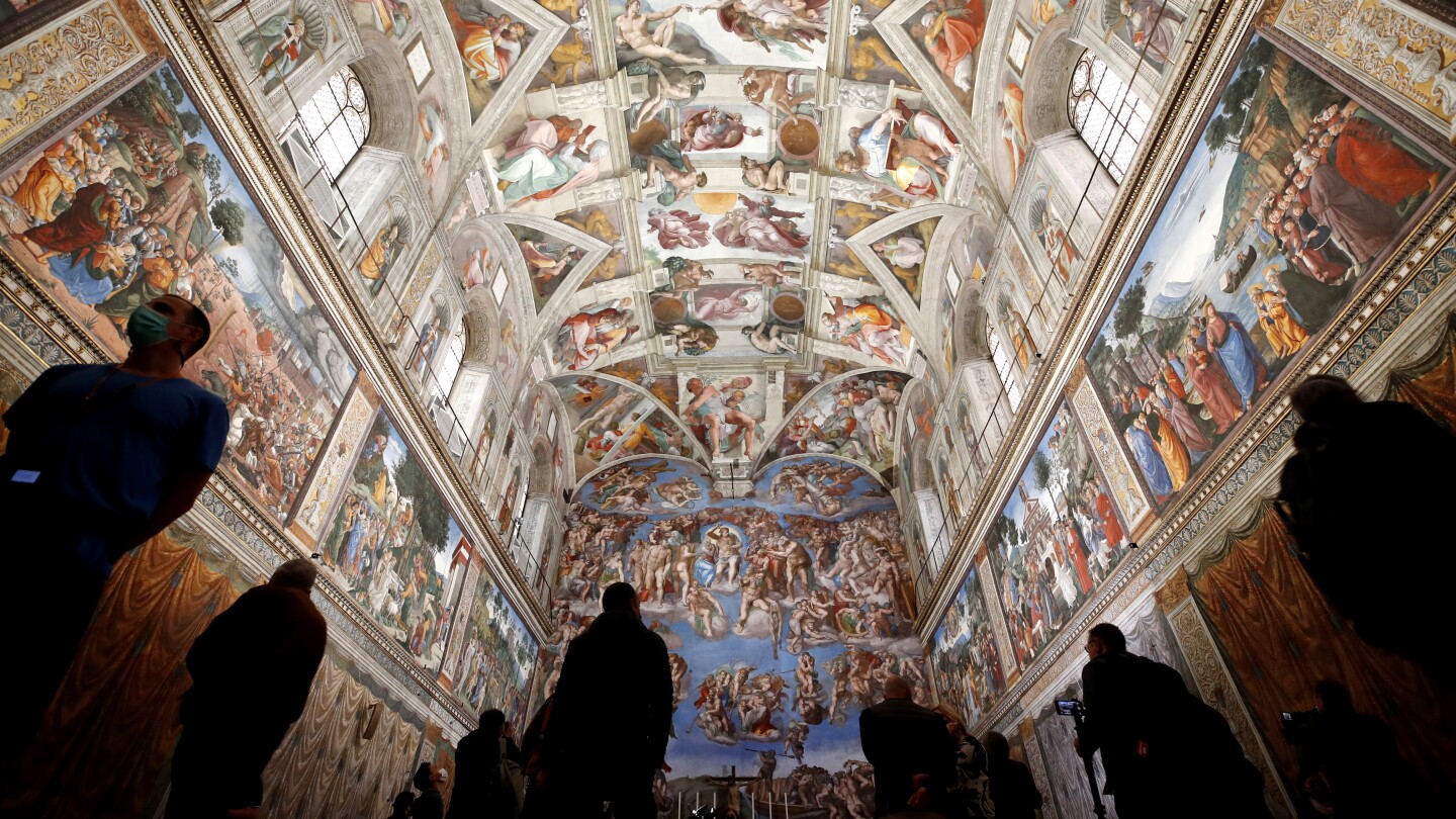 Vatican firefighters set up a chimney at the roof of the Sistine Chapel for the papal election