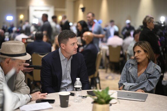 Cincinnati Bengals head coach Zac Taylor, center, talks with reporters during an AFC coaches availability at the NFL owners meetings, Monday, March 25, 2024, in Orlando, Fla. (AP Photo/Phelan M. Ebenhack)
