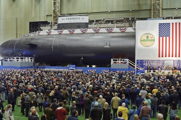 FILE - This Oct. 20, 2018 file photo shows the christening of the Navy's nuclear-powered attack submarine USS Vermont at General Dynamics Electric Boat in Groton, Conn. For decades, the Navy's leading supplier of high-strength steel for submarines provided subpar metal because one of the company's longtime employees falsified lab results, putting sailors at greater risk in the event of collisions or other impacts, federal prosecutors said in court filings Monday, June 15, 2020. The supplier, Kansas City-based Bradken Inc., paid $10.9 million as part of a deferred prosecution agreement, the Justice Department said. The company provides steel castings that Navy contractors Electric Boat and Newport News Shipbuilding use to make submarine hulls. The government did not disclose which subs were affected. (Sean D. Elliot/The Day via AP, File)