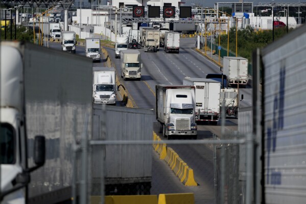 Trucks cross into the Port of Laredo in Laredo, Texas, on Friday, Aug. 9, 2024. (AP Photo/Eric Gay)