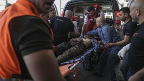 An injured Palestinian is carried into a hospital during an Israeli military raid in the Jenin refugee camp, a militant stronghold in the occupied West Bank, Monday, July 3, 2023. Israeli drones struck targets in the area early Monday and hundreds of troops were deployed. Palestinian health officials said at least five Palestinians were killed. (AP Photo/Nasser Nasser)