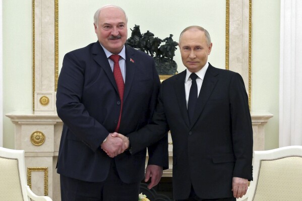 Russian President Vladimir Putin, right, and Belarus President Alexander Lukashenko pose for a photo during their meeting at the Kremlin in Moscow, Russia, Thursday, April 11, 2024. (Gavriil Grigorov, Sputnik, Kremlin Pool Photo via AP)