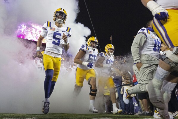 LSU quarterback Jayden Daniels (5) takes the field with offensive lineman Charles Turner III (69) and tight end Mason Taylor (86) before the kickoff of an NCAA college football game against Florida, Saturday, Nov. 11, 2023, in Baton Rouge, La. ( Hilary Scheinuk/The Advocate via AP)