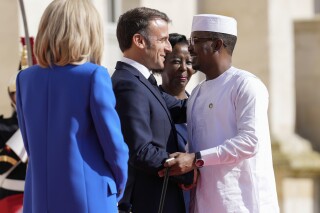 FILE -France's President Emmanuel Macron, left, and Secretary General of the Organisation Internationale de la Francophonie Louise Mushikiwabo, center, welcome Chad's President General Mahamat Idriss Deby Itno for the 19th Francophonie summit in Villers-Cotterets, France, Oct. 4, 2024. (AP Photo/Aurelien Morissard, File)