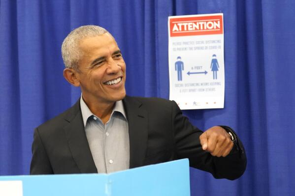 Former President Barack Obama gestures as he casts his ballot at an early vote venue Monday, Oct. 17, 2022, in Chicago. (AP Photo/Charles Rex Arbogast)
