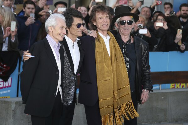 FILE - This April 4, 2016 file photo shows members of The Rolling Stones, from left, Charlie Watts, Ronnie Wood, Mick Jagger and Keith Richards at the Rolling Stones Exhibitionism preview in London. The Rolling Stones will join Lady Gaga, Paul McCartney, Stevie Wonder and Billie Eilish for the upcoming TV special aimed at fighting the coronavirus pandemic. Advocacy organization Global Citizen announced Friday that the Stones will appear Saturday on “One World: Together At Home,” a two-hour televised event that will air at 8 p.m. Eastern simultaneously on ABC, NBC, CBS, iHeartMedia and Bell Media networks. (Photo by Joel Ryan/Invision/AP, File)