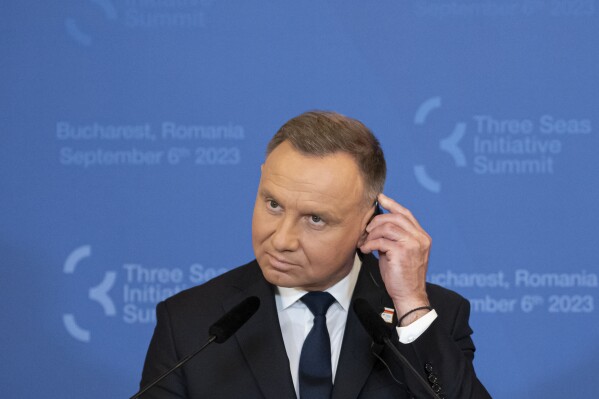 FILE - Poland's President Andrzej Duda adjusts his headphones during a press conference at the Cotroceni Presidential Palace in Bucharest, Romania, Wednesday, Sept. 6, 2023. Poland's minister of digital affairs suggested Friday, Jan. 5, 2024, that President Andrzej Duda check the security of access to his social accounts after a bizarre tweet went out that was almost immediately removed. (AP Photo/Andreea Alexandru, File)